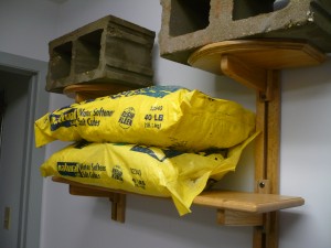A mounted Wooden You shelf carrying weighted test bags away from the wall